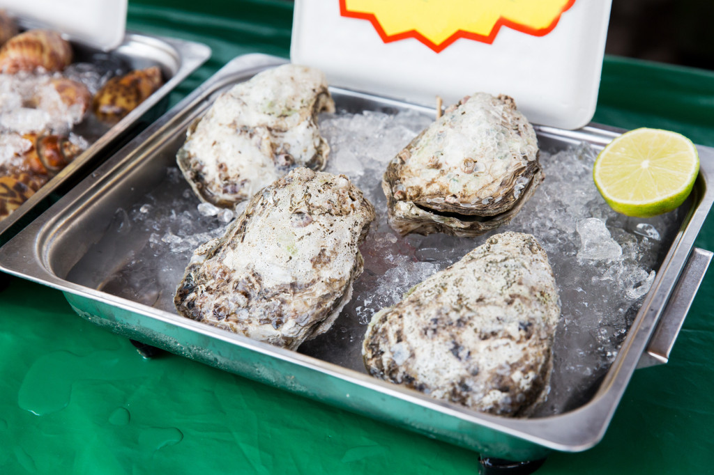 oysters or seafood on ice at asian street market